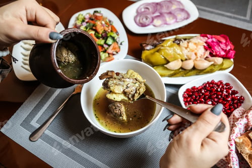 Preview: traditional piti soup with lamb meat and vegetables and side snacks top view