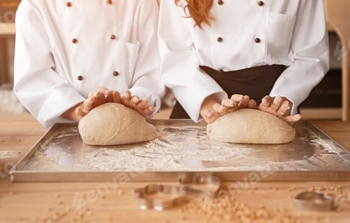 Preview: Children cooking in uniform kneading dough together
