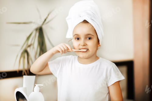 Preview: Cute little girl brushing teeth at home. Morning routine.