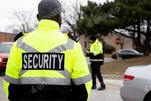 Preview: Rear view of parking security watching over the parking area