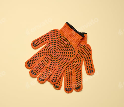 Preview: Textile orange work gloves on a yellow background.