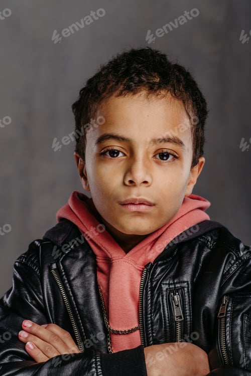 Preview: Portrait of little multiracial boy with leather jacket.