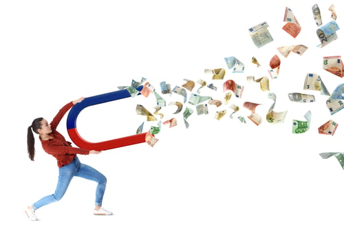 Preview: Woman attracting euro bills with magnet on white background. Concept of money earning
