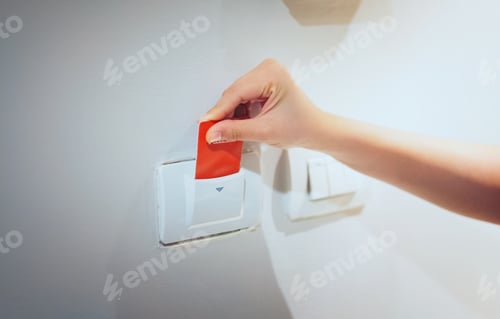 Preview: Closeup women hand insert key card to opening light electronic in hotel room