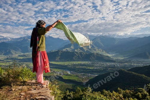 Preview: Nepalese woman holding scarf on cliff edge near Pokhara, Nepal
