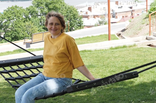 Preview: female portrait. girl of European appearance in summer in a yellow T-shirt in the park.