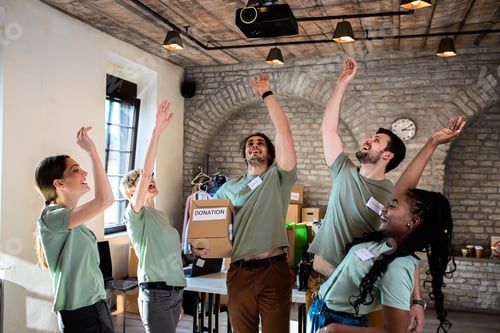 Preview: Portrait of volunteers with working in community charity donation center.