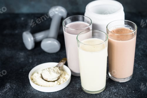 Preview: Protein cocktails and dumbbells, sport and fitness concept.