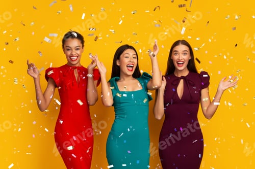 Preview: Three Party Girls Standing Under Falling Silver Confetti, Yellow Background