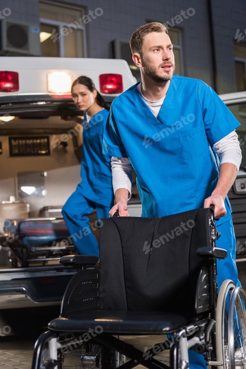 Preview: male and female paramedics at work in the evening