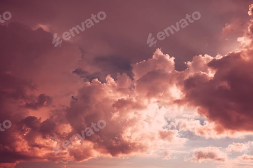 Preview: Toned Pink-yellow Clouds. Toned Cumulus Clouds Float In Blue Sky. Saturated Yellow Colors Of Clouds