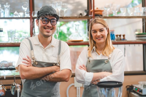 Preview: Coffee shop small business shop owner couple or partner wearing apron helping each other