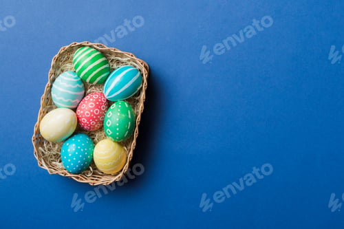 Preview: Multi colors Easter eggs in the woven basket on colored background