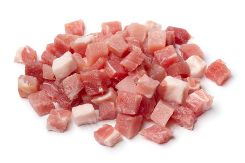 Preview: Heap of smoked bacon cubes isolated on white background
