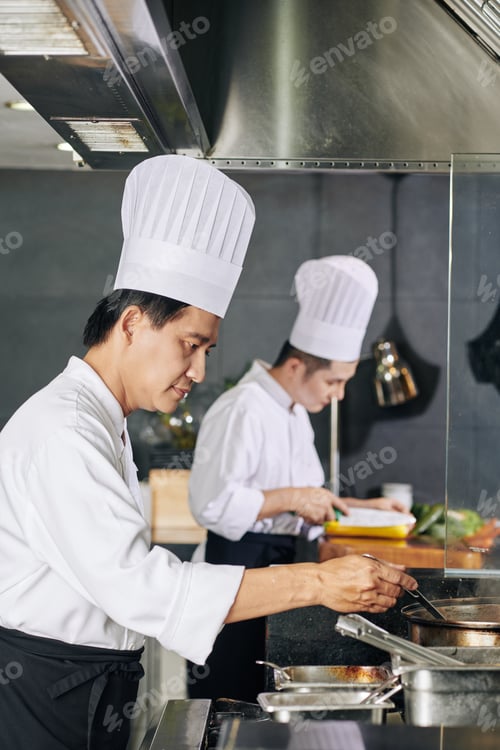 Preview: Asian chef preparing food at the restaurant