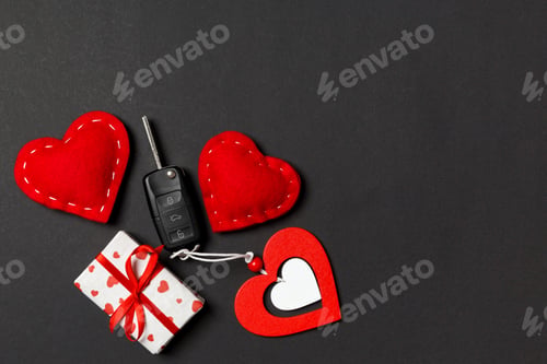 Preview: Top view of car key, gift boxes and toy hearts on colorful background. Saint Valentine