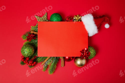 Preview: Frame of Christmas tree branches and decorations with blank card and space for text red background