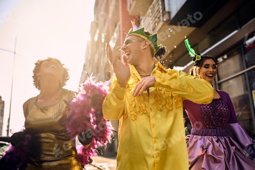 Preview: Cheerful friends having fun and dancing on Brazilian carnival parade on the street.