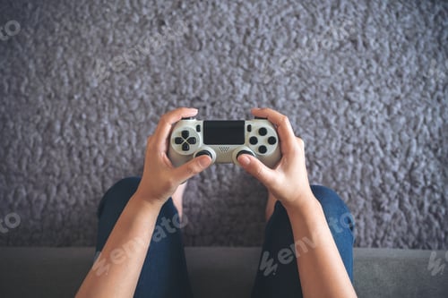 Preview: hands holding the game controller while playing games