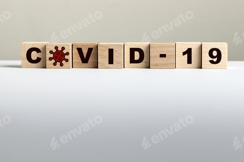 Preview: COVID-19 written on wooden blocks on light background