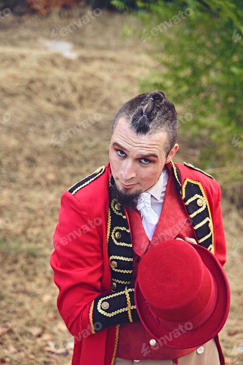 Preview: Male performer offering hat to camera