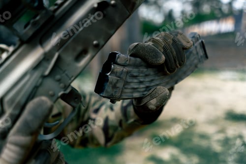 Preview: close-up military tactical strategy NATO rifle position for reloading a weapon training at