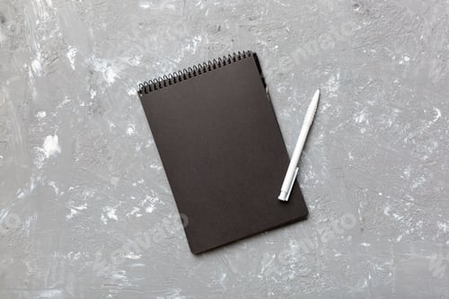 Vista previa: school notebook on a colored background, spiral black notepad on a table Top view