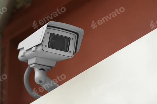 Preview: Modern CCTV security camera on building outdoors. Space for text
