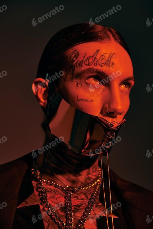 Preview: vertical shot of handsome stylish man in futuristic laced mask looking away, fashion concept