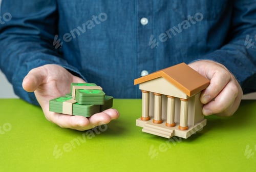 Preview: Bank building and stacks of money in a man's hands. Financial literacy. Capital and investments.