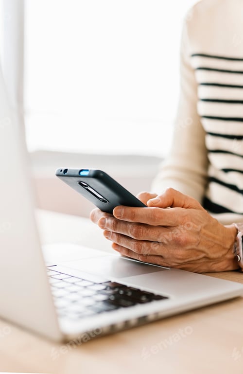 Preview: Close-up view of woman hands using cell phone device at office workplace