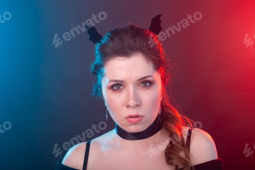 Preview: Halloween, holidays and carnival concept - vamp woman in collar and bat's ears in gothic style