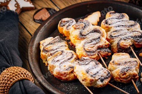 Preview: Sweet puff pastry in form of Christmas tree, filled with chocolate on festive table