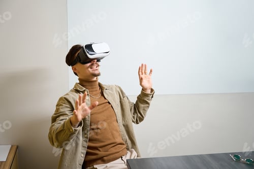 Preview: Joyous corporate worker undergoing virtual reality training in workplace
