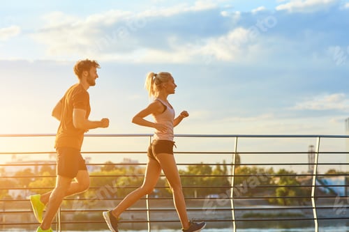 Preview: Modern Woman And Man Jogging / Exercising In Urban Surroundings Near The River.