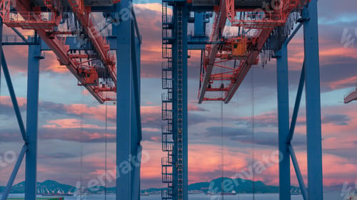 Preview: crane loading cargo container from truck to container ship in the international terminal