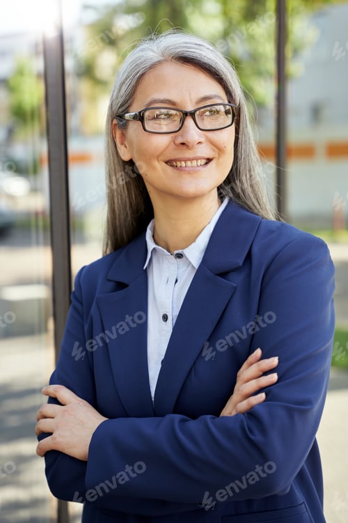 Preview: Confident Professional Woman Wearing Blue Jacket and Glasses