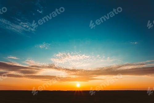 Preview: Sunset Sunrise Over Field Or Meadow. Bright Dramatic Sky And Dar