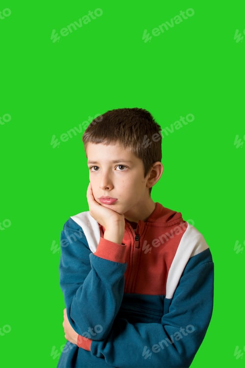 Preview: boy in a casual style feeling annoyed and showing sad expression on green background.