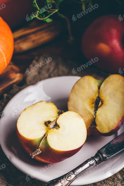 Preview: Two Halves of Red Apple on White Plate