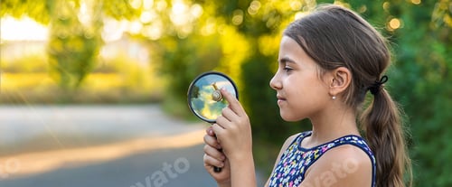 Preview: A child is studying a snail in the park. Selective focus.