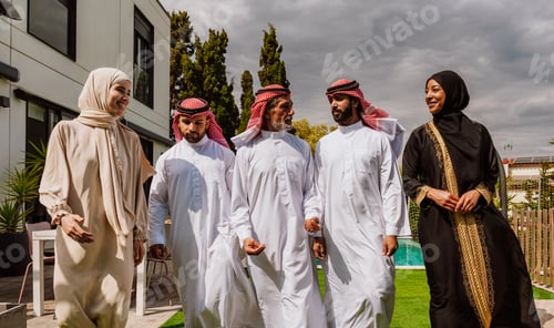 Preview: Arab multi-generational family gathering and discussing outdoors