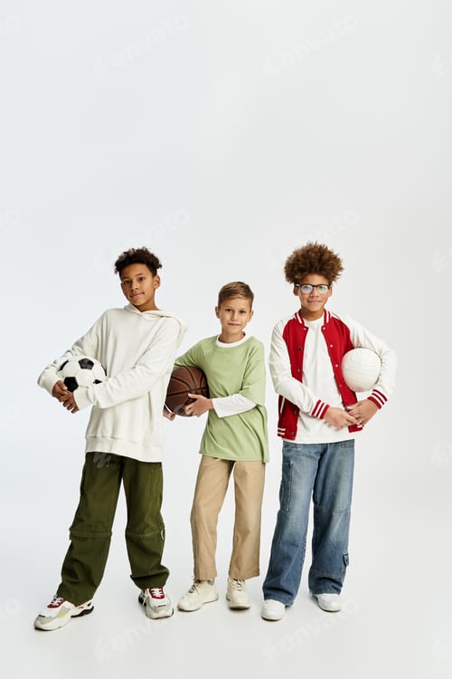 Preview: Boys showcasing their friendship in vibrant outfits with sports equipment in hand