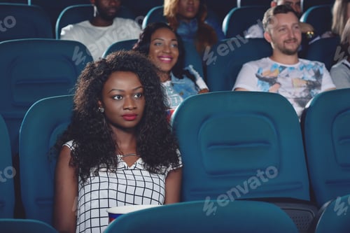 Preview: Africanl sitting alone and watching movie in cinema