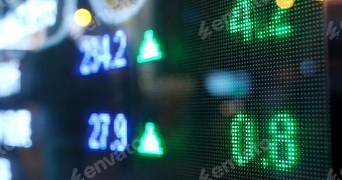 Preview: Display of Stock market quotes with city scene reflect on glass
