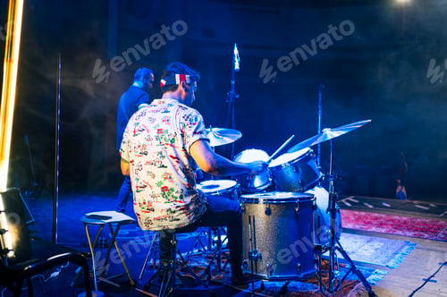Preview: Rock and roll group performing live.