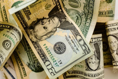 Preview: wad of dollar bills on a table