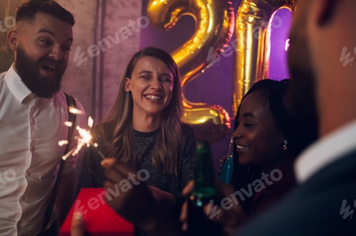 Preview: Happy group of friends celebrate New Year's Eve and exchanging gifts