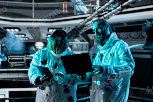 Preview: Teamworking astronauts brainstorming to confirm suit integrity using laptop