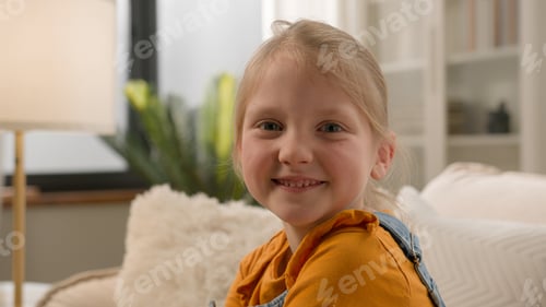 Preview: Positive happy Caucasian kid schoolchild gen z child pose looking at camera alone at home healthy